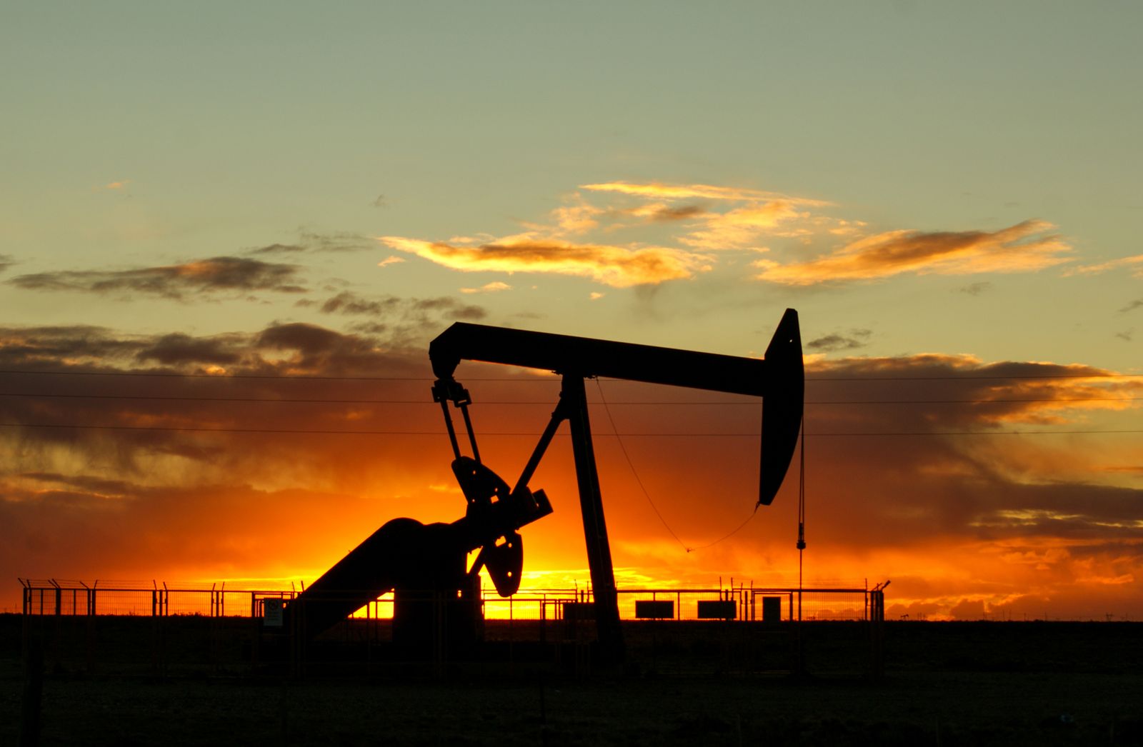 Oil production wellhead at sunset
